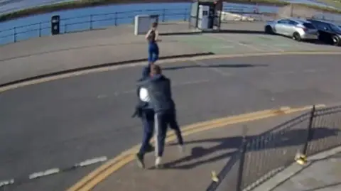 Teenage boys running in the street