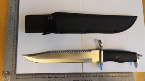 CPS A 15in (37.5cm) hunting knife next to a black sheath