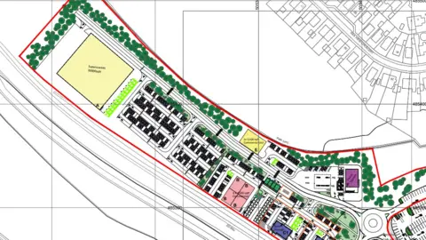 Lichfields The image is an illustrative map showing a proposed retail park and surrounding development. Outlined in red, the site includes a large supermarket building, multiple smaller retail units arranged in blocks, car parking areas, internal access roads, and landscaped green spaces with trees. A roundabout and connecting road network are shown at one end of the site, linking it to nearby residential streets, which are depicted in light grey. The plan is drawn to scale with grid lines and annotations.