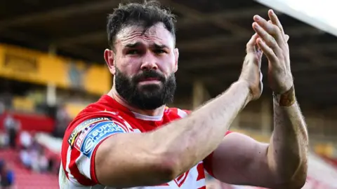 St Helens prop Alex Walmlsey applauds the fans
