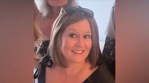 Hayley Lant Hayley Lant smiles at the camera. She has brown hair cut into the style of a bob with sunglasses resting on her head.