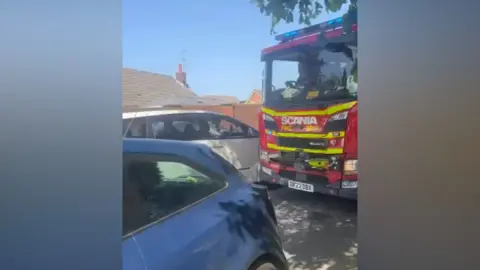 Julie Swift A fire engine struggles to pass cars in Formby on Bank Holiday Monday 25 May 2026.