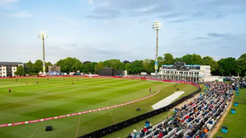Supplied The St Lawrence Ground in Canterbury, Kent. People can be seen in the crowd with cricketers in the field. 