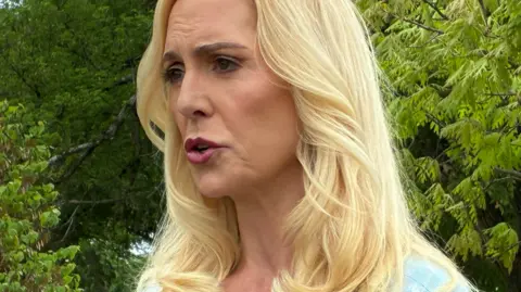 Sigrid McCawley head and shoulders picture at a Virginia Giuffre memorial in Washington DC