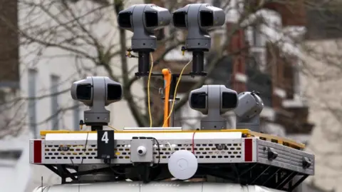 PA Cameras mounted on top of van. Around four separate grey cameras can be seen.