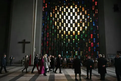 PA Media German president Frank-Walter Steinmeier and others are pictured inside Coventry Cathedral 