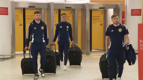 BBC Anthony Ralston, Lawrence Shankland and James Forrest arrive at Glasgow Airport