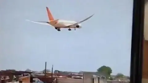 Air India passenger plane descends over neighbourhood