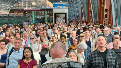 Supplied London St Pancras station very crowded with people waiting for a train update