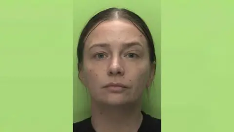 Nottinghamshire Police A headshot of Paige Tomlinson against a green background.