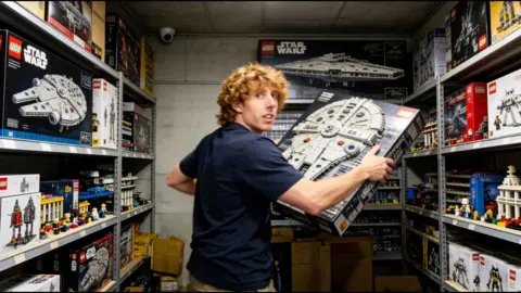 YouTube Reckless Ben looks at the camera surrounded by Star Wars Legos in a storage closet. 