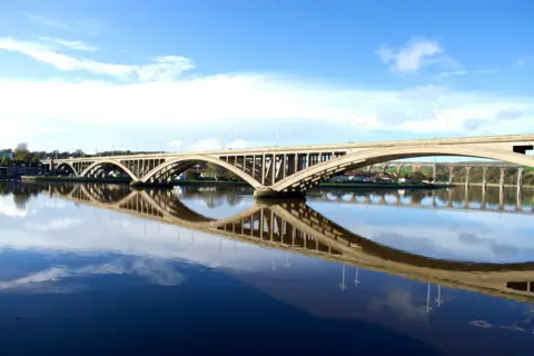 Ray Goti The arches of a bridge and viaduct are reflected in the River Tweed