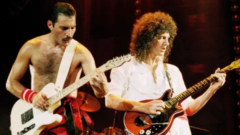 Getty Images Queen's Freddie Mercury and Brian May both playing guitars on stage in 1984