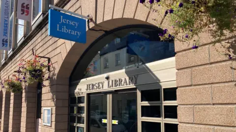 The front entrance of Jersey Library with the door, signage and banners visible
