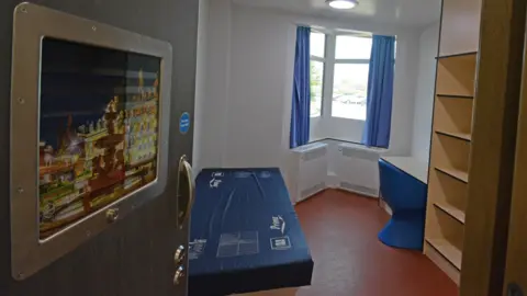 Leicestershire Partnership NHS Trust Inside a psychiatric patient room. There is a Leicestershire landmark in a frame on the door.