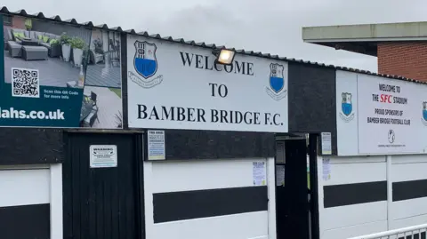 Signs welcoming visitors to Bamber Bridge outside the ground