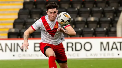 Mason Hancock chases the ball during a game for Scottish Championship club Airdrieonians