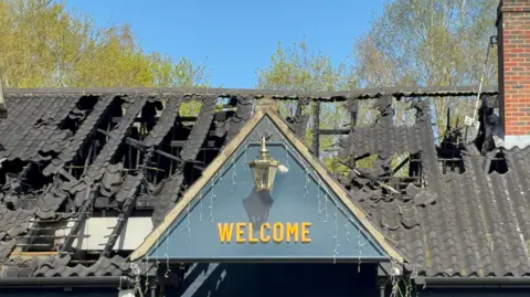 Edd Smith/BBC The black roof of the Old Mill pub. It is damaged by the fire and parts of the tiling are missing. 
