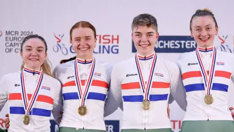From left, Grace Lister, Kate Richardson, Izzy Sharp and Madelaine Leech with gold medals around their necks after winning the Women's Team Pursuit Finals at the British Cycling National Track Championships 2024
