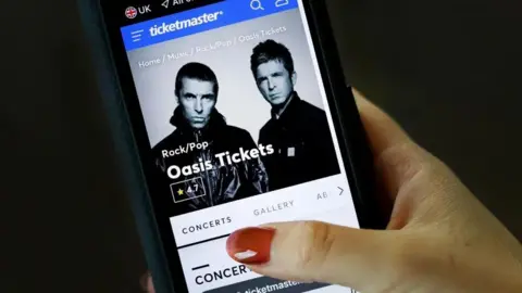 EPA-EFE/REX/Shutterstock Mobile phone with Oasis tickets on it.