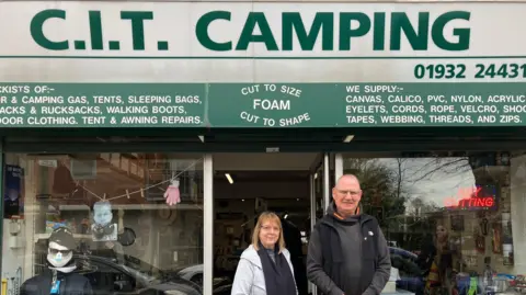 Emily Dalton Martin and a co-worker stand outside the CIT Camping Shop
