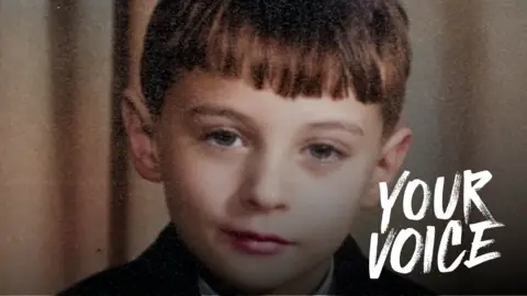 Alex McBratney A picture of a young boy with short, brown hair looking straight at the camera