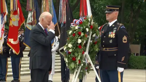 US President Joe Biden places a wreath of flowers astatine  the Tomb of the Unknown Soldier