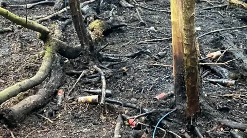 Forestry England Glass bottles and fire-damaged ground