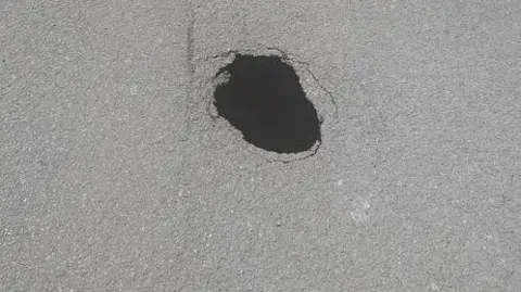 Swindon Borough Council A sinkhole on a road