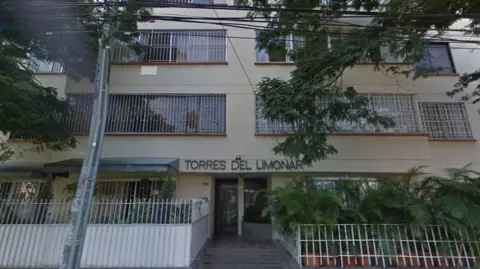 Google Maps / Captura Torres del Limonar in 2019 as seen on Google Maps - its an indistinct looking building with a cream front, with shutters on windows 