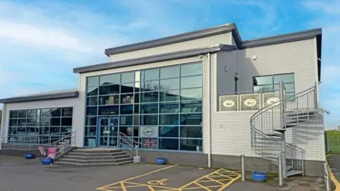 Farndon Marina and Christie and Co A large glass-fronted metal building