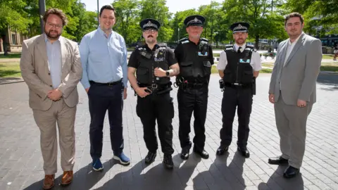 Three police officers, in uniform, standing with Tees Valley Mayor Ben Houchen, Middlesbrough Mayor Chris Cooke and Police and Crime Commissioner Ben Storey.