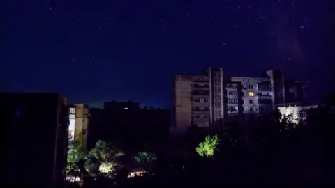 Residential buildings at night during a temporary power outage, which local authorities said was caused by technological disturbances in the peninsula’s energy grid