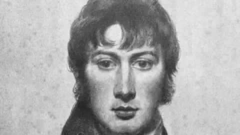 Getty Images A self portrait of John Constable. It is a black and white chalk and pencil drawing. He depicted himself with dark hair that rests over his forehead and he wears a dark jacket with a large collar and a white cravat around his neck. He is expressionless and has dark eyes. 