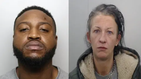 The mugshots of Marvn Sutton and Charlene Thomas. Marvin is wearing a grey t-shirt and is starting down his nose at the camera. Charlene is wearing a green parka hoodie, grey shirt and gold chain. 