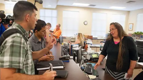 Robbie Blankenship (L) stands next to his partner of 20 years, Jesse Cruz, of Corpus Christie, Texas, as they try to get a marriage licence from Rowan County Clerk of Courts Kim Davis in Morehead, Kentucky, on 2 September 2015 