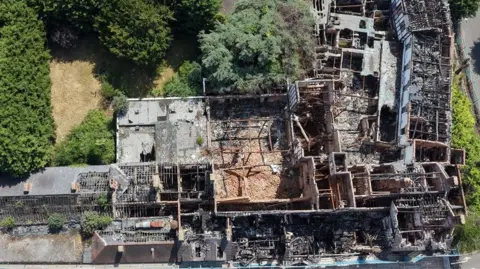 WYCHAVON DISTRICT COUNCIL An aerial view of the old Raven Hotel in Droitwich - showing the roof blown off the building and piles of rubble on the floor.