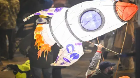 Stuart Walker A man flies a rocket display