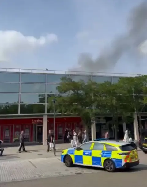 Kam Singh Smoke coming from the top of the shopping centre 