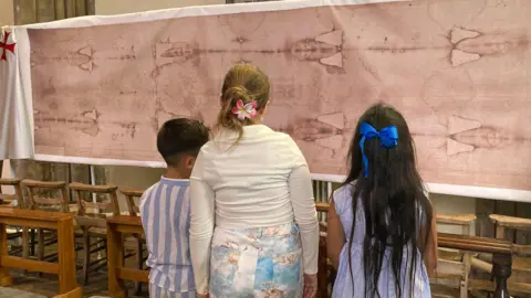 Children looking at the display inside Crowland Abbey