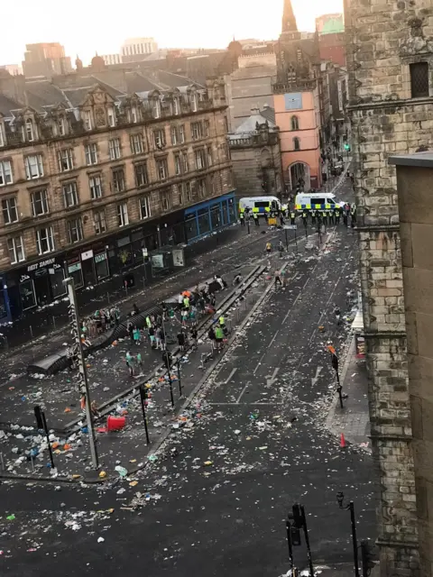 Birds eye view showing litter strewn streets as the sun rises at Glasgow Cross