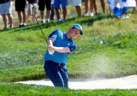 Reuters Robert MacIntyre plays out of a bunker during the Ryder Cup