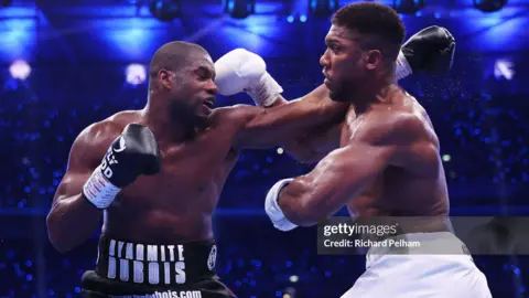 Getty Images Anthony Joshua and Daniel Dubois fighting at Wembley on 21 September.