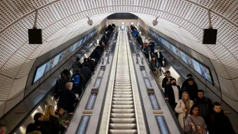 Getty Images Commuters on escalators