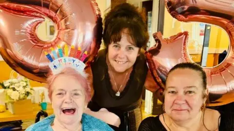 family handout Julie Watson and Jakkie Hope with their mum Kath on her birthday