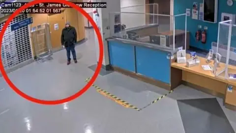 Counter Terrorism Policing North East A man wearing dark clothing and a grey hat stands inside a hospital reception. He is circled. There is nobody else in the reception area.