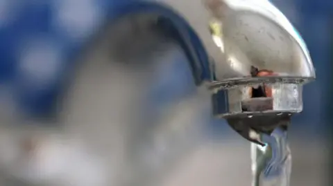 NEIL HALL/EPA-EFE/REX/Shutterstock Water pouring from tap