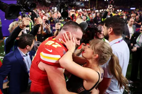 Getty Images Taylor Swift embracing Travis after he won February's Super Bowl