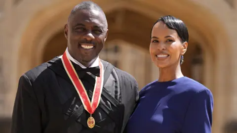 Sir Idris Elba, activist, actor and musician, poses with wife Sabrina Dhowre Elba, after being made a Knight Bachelor by King Charles III at Windsor Castle, Windsor, Britain, June 2, 2026