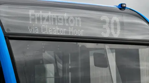 Close view of the front of a bus showing a 30 Frizington via Cleator Moor destination panel  